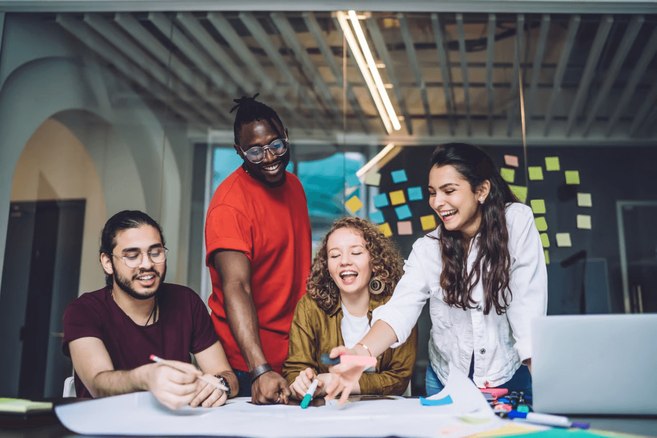 Diverse team collaborating with smiles in office space.
