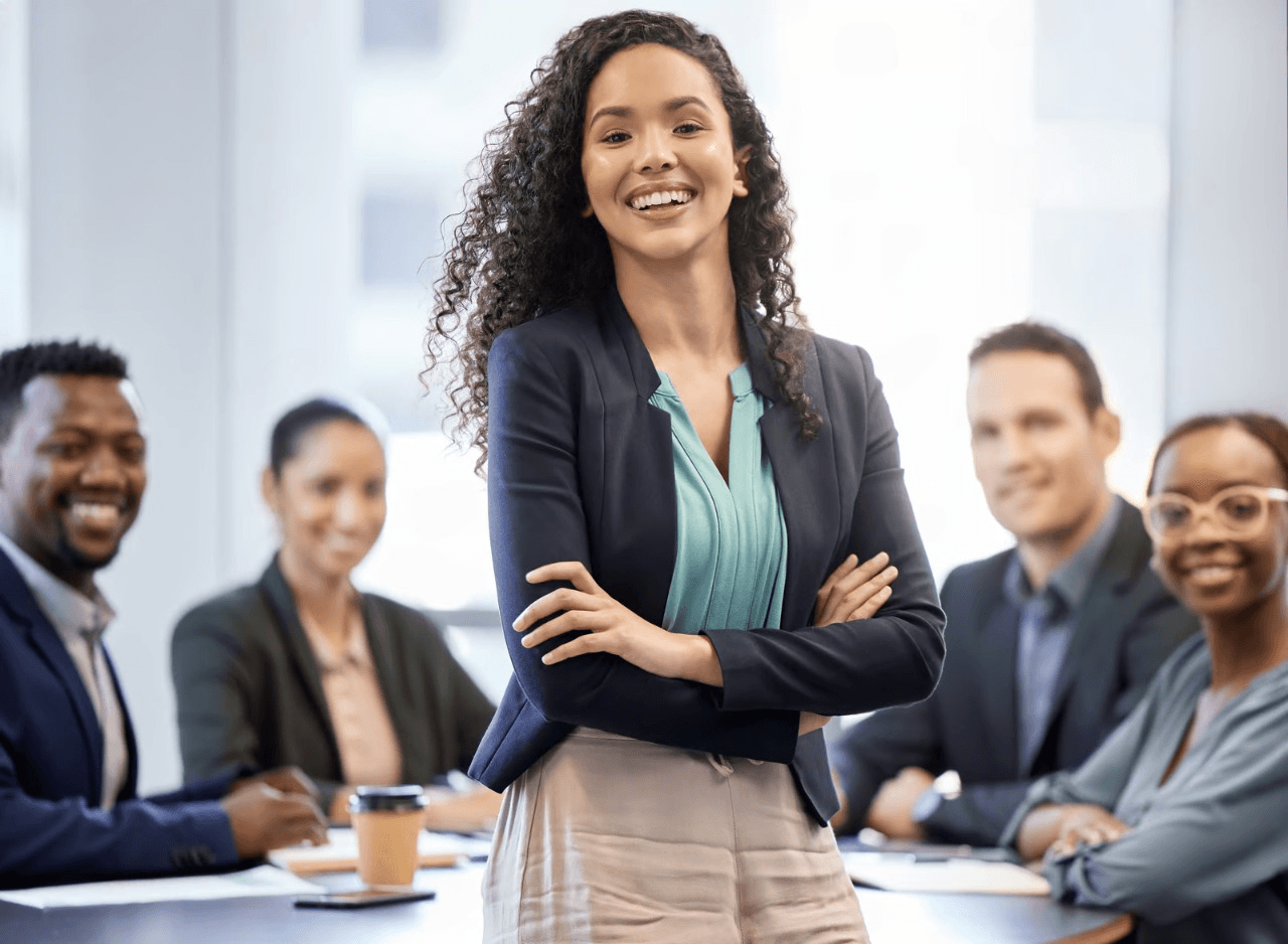 Confident woman leads business meeting with team.
